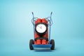 3d rendering of big dynamite bundle with time bomb on blue hand truck on light-blue background. Royalty Free Stock Photo