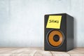 3d rendering of black audio column speaker with yellow post-it note `Silence`, standing on wooden surface.