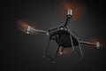 3d rendering of black drone with orange propellers, and black camera attached, viewed from below, flying on dark gray