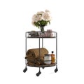 3D rendering of a black metal rolling bar cart with flowers and towels on a white background.