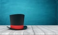 3d rendering of black tophat with red ribbon standing on wooden table near blue wall with copy space. Royalty Free Stock Photo