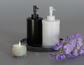 3D Rendering black and white lotion bottles placed in a black me