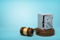 3d rendering of broken damaged metal bank safe on round wooden block and brown wooden gavel on blue background