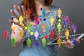 3D rendering of a businesswoman pointing at a group of colorful people icons