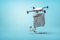 3d rendering of camera drone carrying unlocked light gray money safe, dollar bills falling out, on light blue background