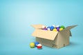 3d rendering of cardboard box full of colorful snooker balls on blue background.