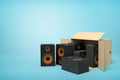 3d rendering of cardboard box lying sidelong with black audio speakers inside and three outside on light-blue background Royalty Free Stock Photo