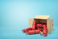 3d rendering of cardboard box lying sidelong full of red fire extinguishers on blue background.