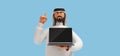 3d rendering, cartoon character arab man wears traditional clothes and shows finger up, holds laptop with black screen. Business