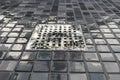 3d rendering of chrome metal gutter with water drops and mosaic tiles floor in the evening light