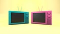 Close up pink and green televisions on yellow background.