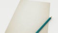 Close up of white old paper and blue green pencil mock up put on the desk Royalty Free Stock Photo
