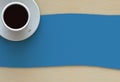 Coffee cup with blue fabric on wood table