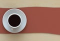 Coffee cup with red fabric on wood table