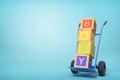 3d rendering of colorful alphabet toy blocks showing `BABY` sign on a hand truck on blue background Royalty Free Stock Photo