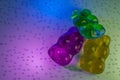 3d rendering. colorful gummy bears covered in sugar grains on colorful background. concept of tenderness and gluttony for children