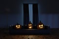 3d rendering of creepy jack o` lanterns sitting on the sofa in the darken living room