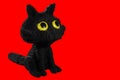 3d rendering of a cute black cat in voxel graphics style, isolated on red background for easy to cut out the background