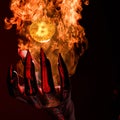 3D Rendering of a Devil Hand Burns a Golden Bitcoin with Hot Flame