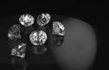 3d rendering. Diamonds group with reflection on black background with copy space