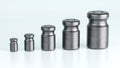 3D rendering of different size of metal calibration weight on color background Royalty Free Stock Photo