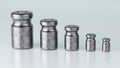 3D rendering of different size of metal calibration weight on color background Royalty Free Stock Photo