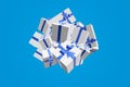 3d rendering explosion gifts boxes fly on a blue background. Gift surprise for Christmas, New Year, Valentine`s Day