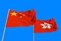 3d rendering. flowing China and Hong Kong national flags with clipping path isolated on blue sky background.