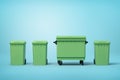 3d rendering of four green trash cans standing in row on light-blue background Royalty Free Stock Photo