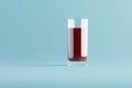 3d rendering of a full glass of cherry juice on a blue background