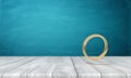 3d rendering of gold ring on wooden table near blue wall with a lot of copy space. Royalty Free Stock Photo