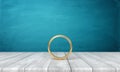 3d rendering of gold ring on wooden table near blue wall with a lot of copy space. Royalty Free Stock Photo