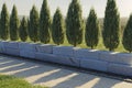 3d rendering of a green garden bounded by thuja treeline and granite ashlars