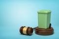 3d rendering of green trash bin on round wooden block and brown wooden gavel on blue background