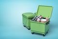 3d rendering of green trash bins with popcorn buckets, film reels and movie clapper inside on blue background