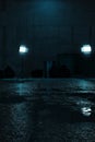 3d rendering of grunge backyard and wet street asphalt at night illuminated from blue studio lights