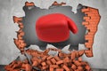 3d rendering of a huge red boxing glove punches right throw a red brick wall with rubble lying around. Royalty Free Stock Photo