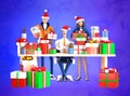 Businessman and his team next to desk with lots of presents and Christmas gifts. Royalty Free Stock Photo