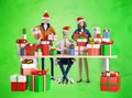 Businessman and his team next to desk with lots of presents and Christmas gifts. Royalty Free Stock Photo