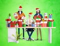 Businessman and his team next to desk with lots of presents and Christmas gifts. Royalty Free Stock Photo