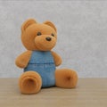 3D rendering illustration of a sitting brown toy bear in blue denim jeans