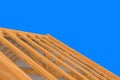 3d rendering. incomplete building new roof wood house construction work with clipping path isolated on blue background.