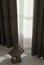 japanese metal lantern next to bright window with curtains