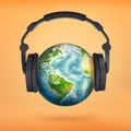 3d rendering of large black headphones placed on an Earth globe pretending it`s a head. Royalty Free Stock Photo