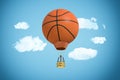 3d rendering of large orange basketball ball used as a canopy for a hot air balloon flying in the cloudy sky. Royalty Free Stock Photo