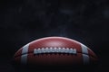 3d rendering of a leather ball for American football lying with its seams in focus on a dark background. Royalty Free Stock Photo