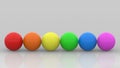 3d rendering. LGBT rainbow color Golf Balls row on gray wall background Royalty Free Stock Photo