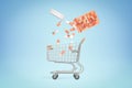 3d rendering of medical pills falling from a plastic jar into shopping cart on blue background Royalty Free Stock Photo