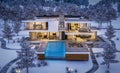 3d rendering of modern house by the river in winter night Royalty Free Stock Photo