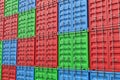 3d rendering of multiple red, blue and green closed shipping containers stacked on one another. Royalty Free Stock Photo